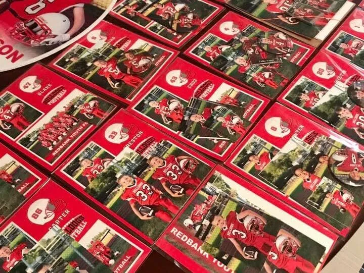 Youth football player trading cards spread across a table